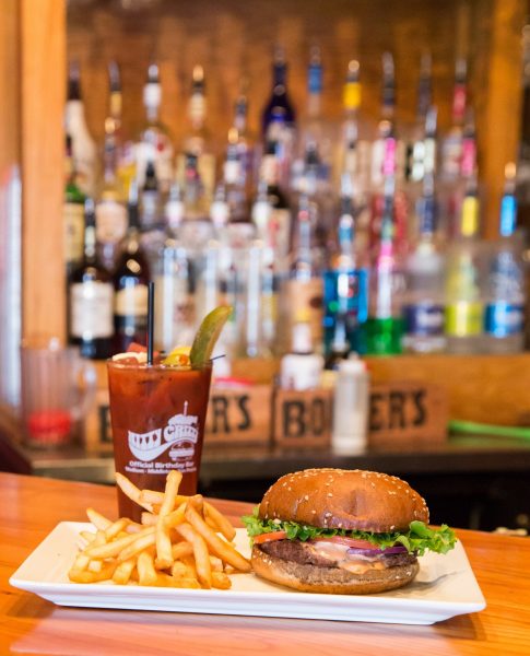 A plate of french fries and a burger.