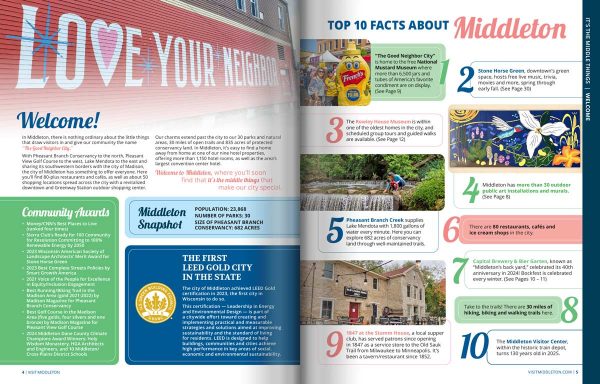 a couple and two children standing on a bridge in the woods.