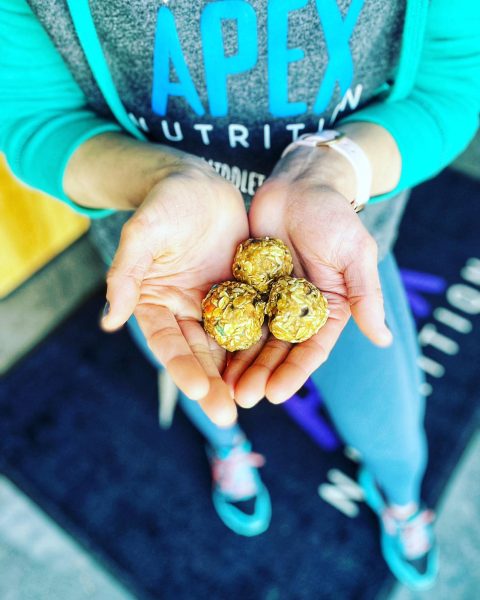 A person holding two small balls in her hands.