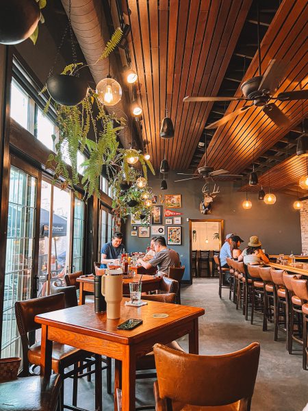 A group of people sitting at tables in a restaurant.