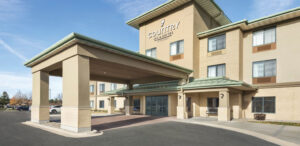 the front of a hotel with a parking lot