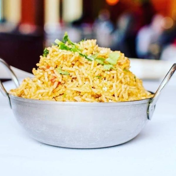 A bowl of rice sitting on top of a table.