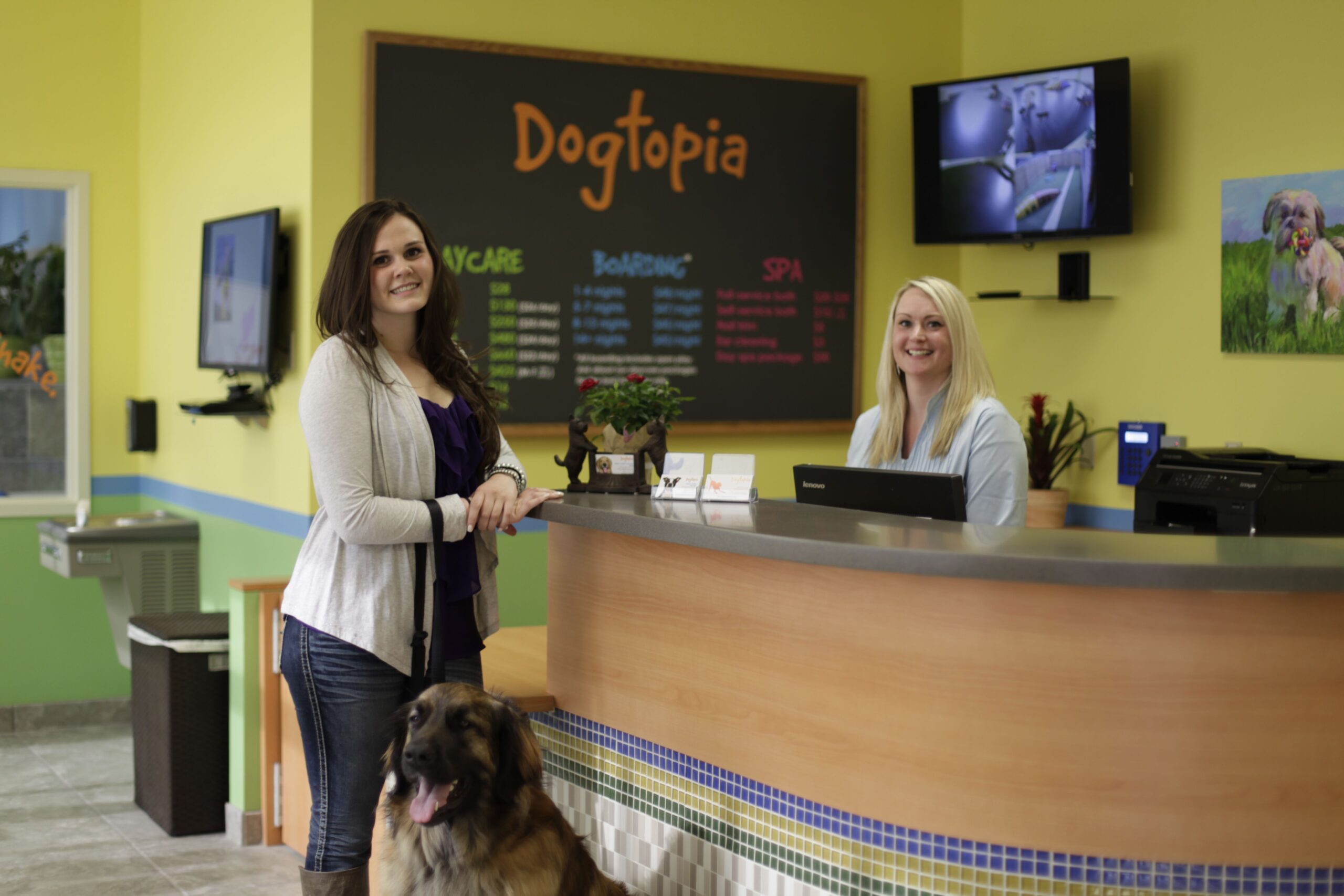 a woman standing in front of a counter with a dog