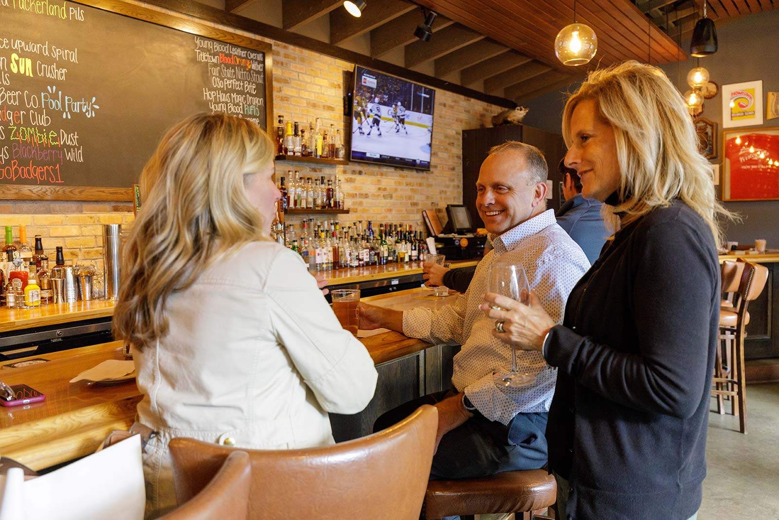 a group of people standing around a bar