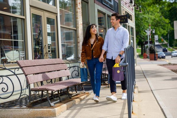 a man and a woman walking down a sidewalk
