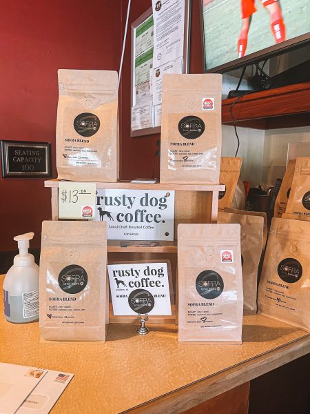 A counter with several bags of coffee on it.