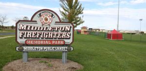 a sign for a fire department in the middle of a field