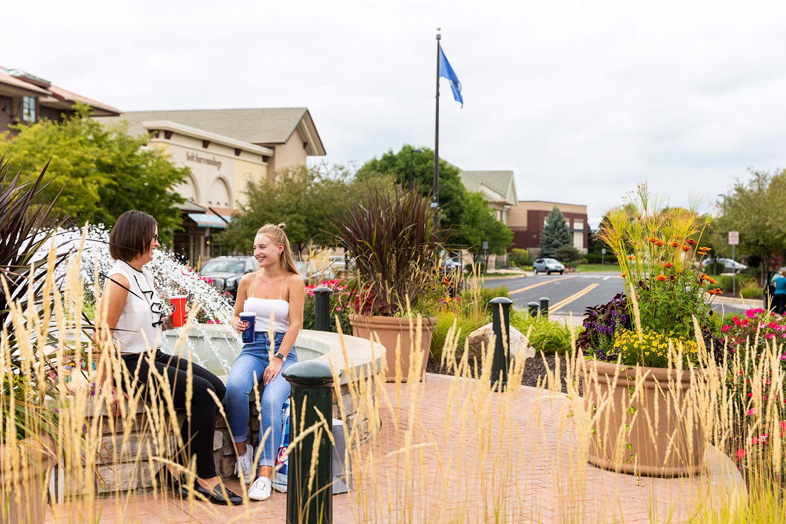 a couple of women sitting on top of a bench