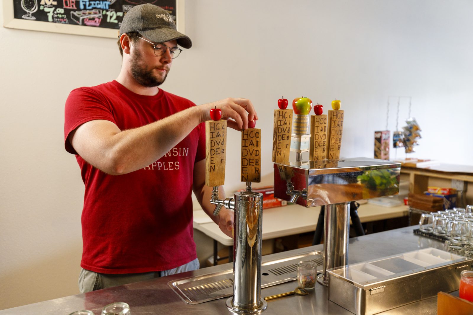 A man pouring a beer at a bar.