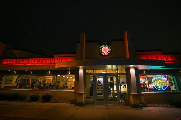 A restaurant is lit up at night.