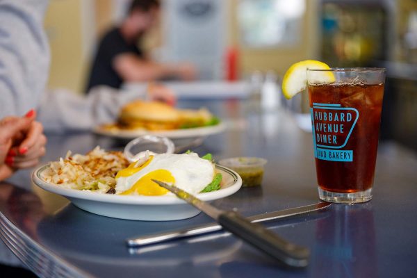 a person sitting at a table with a plate of food
