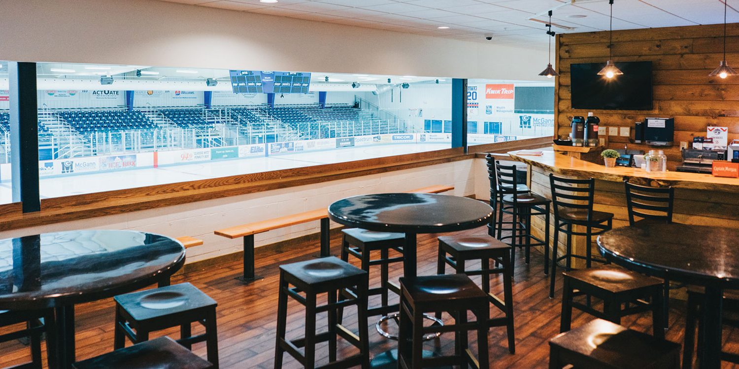 a restaurant with a view of a hockey stadium