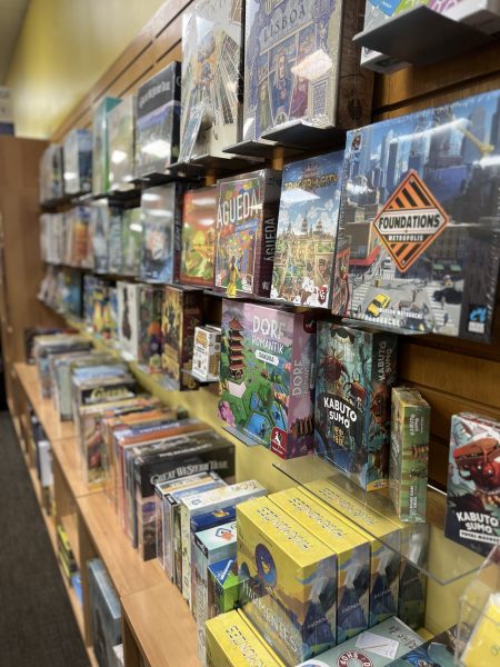 A family-friendly store display with shelves filled with colorful boxes of various board games.
