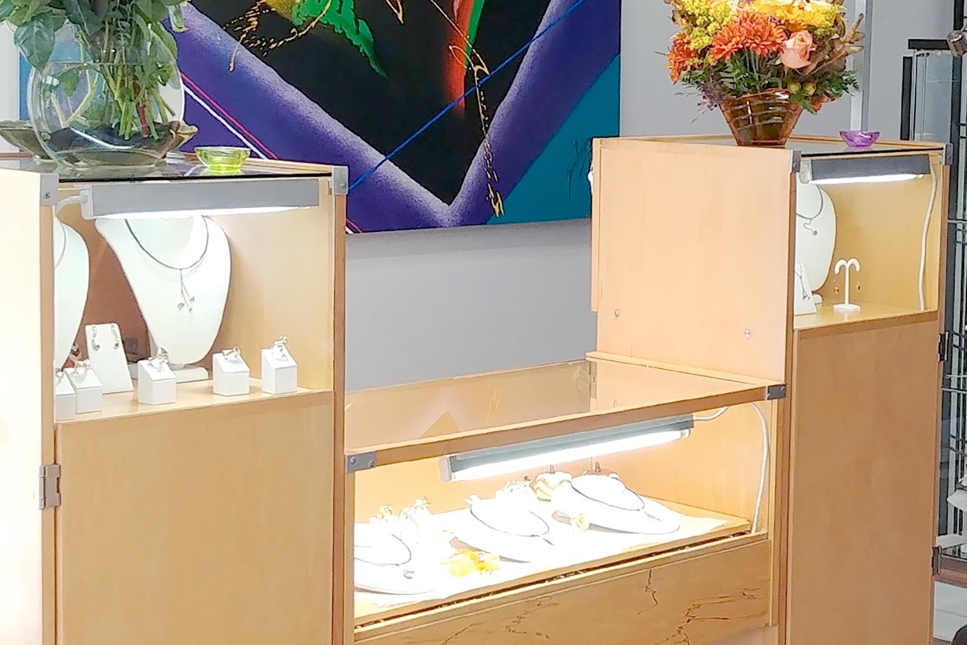 a display case with shoes and flowers in it