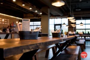 a wooden table with a basket of papers on top of it