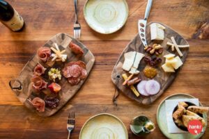 a wooden table topped with plates of food