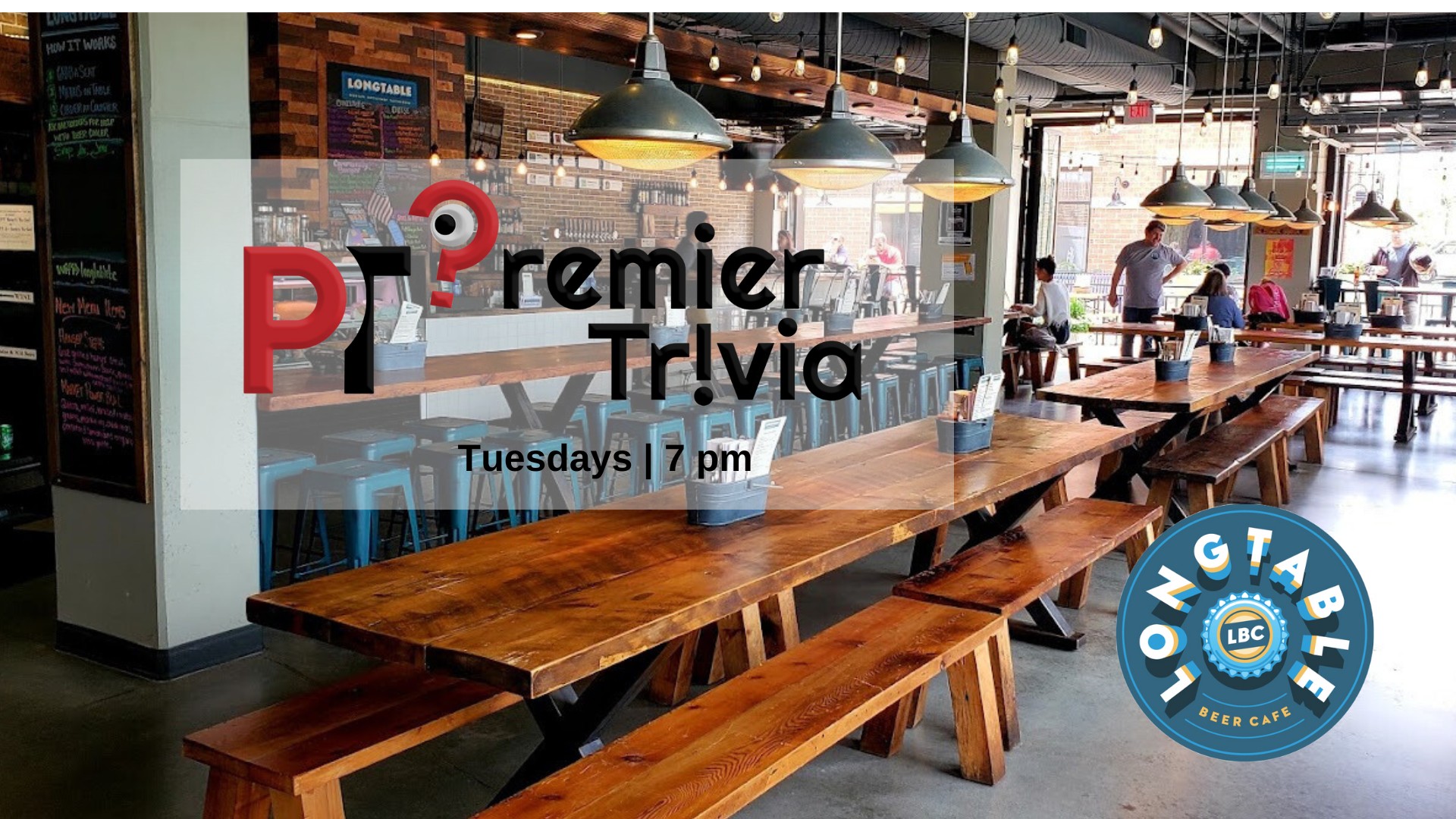 Interior of a modern beer café with long wooden tables, pendant lights, and a sign advertising "Premier Trivia, Tuesdays | 7 pm" at Long Table Beer Café.