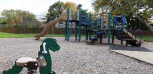 a playground with a slide and a toy horse
