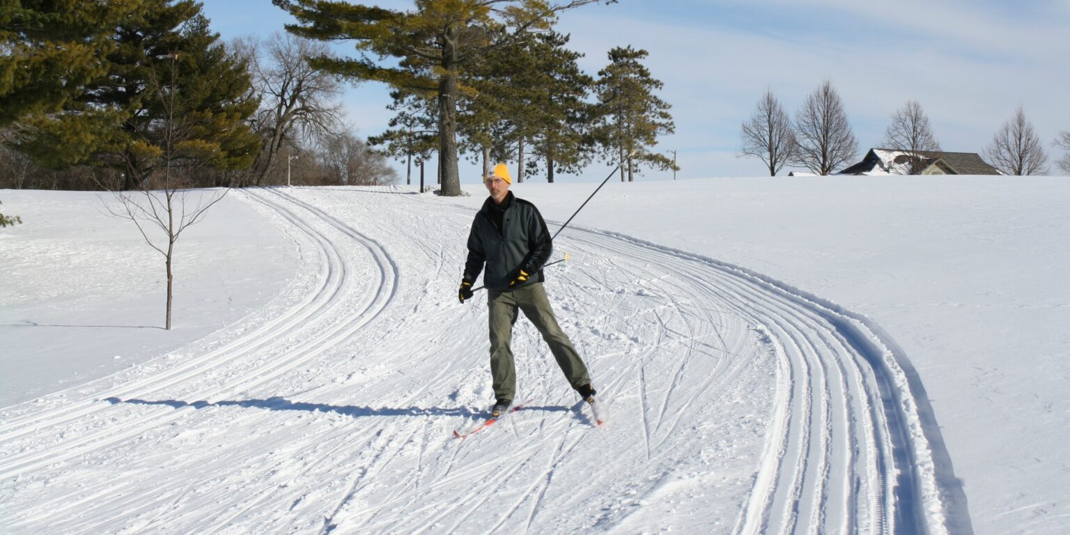 a man riding skis down a snow covered slope