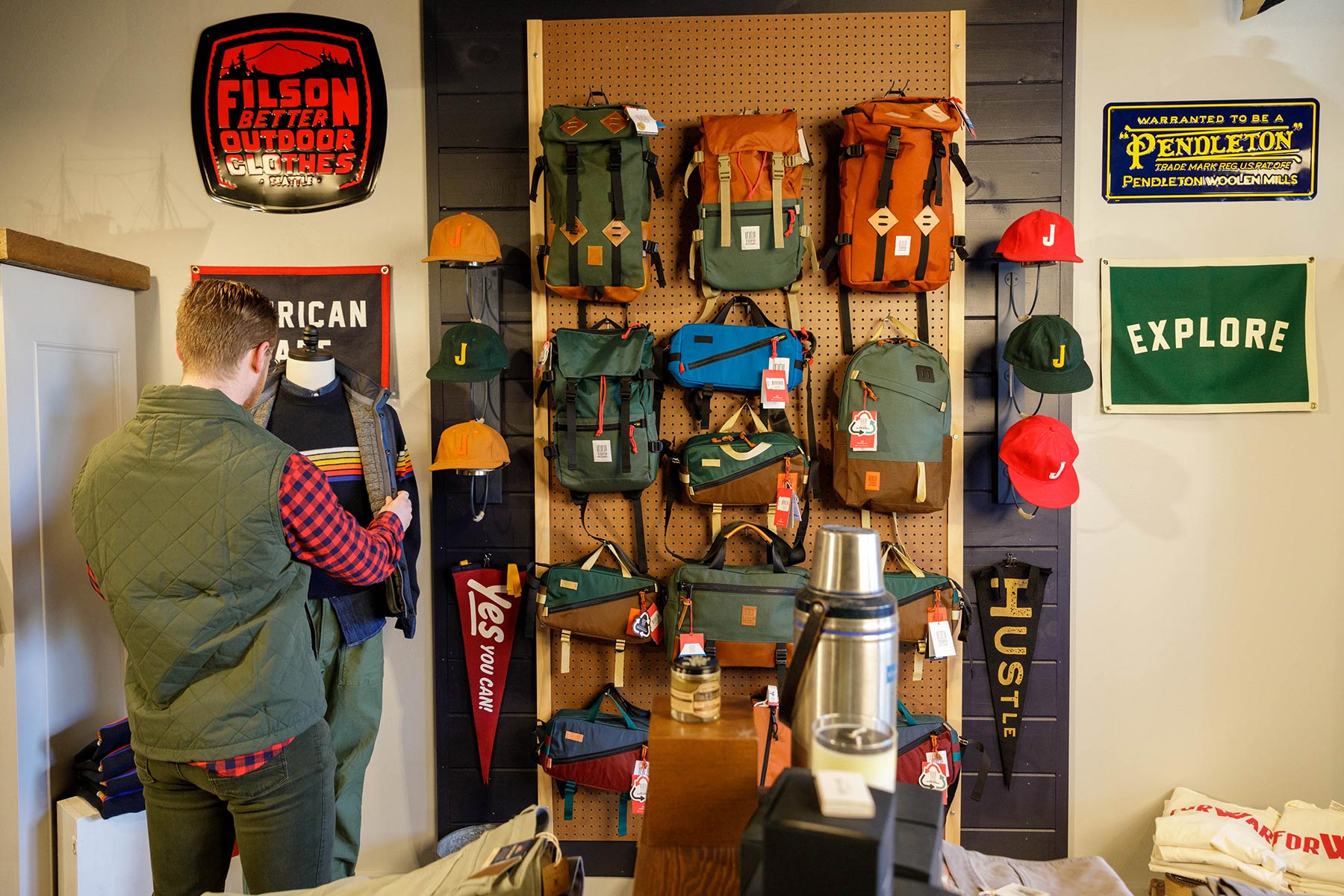 A customer examining outdoor gear at a retail store.