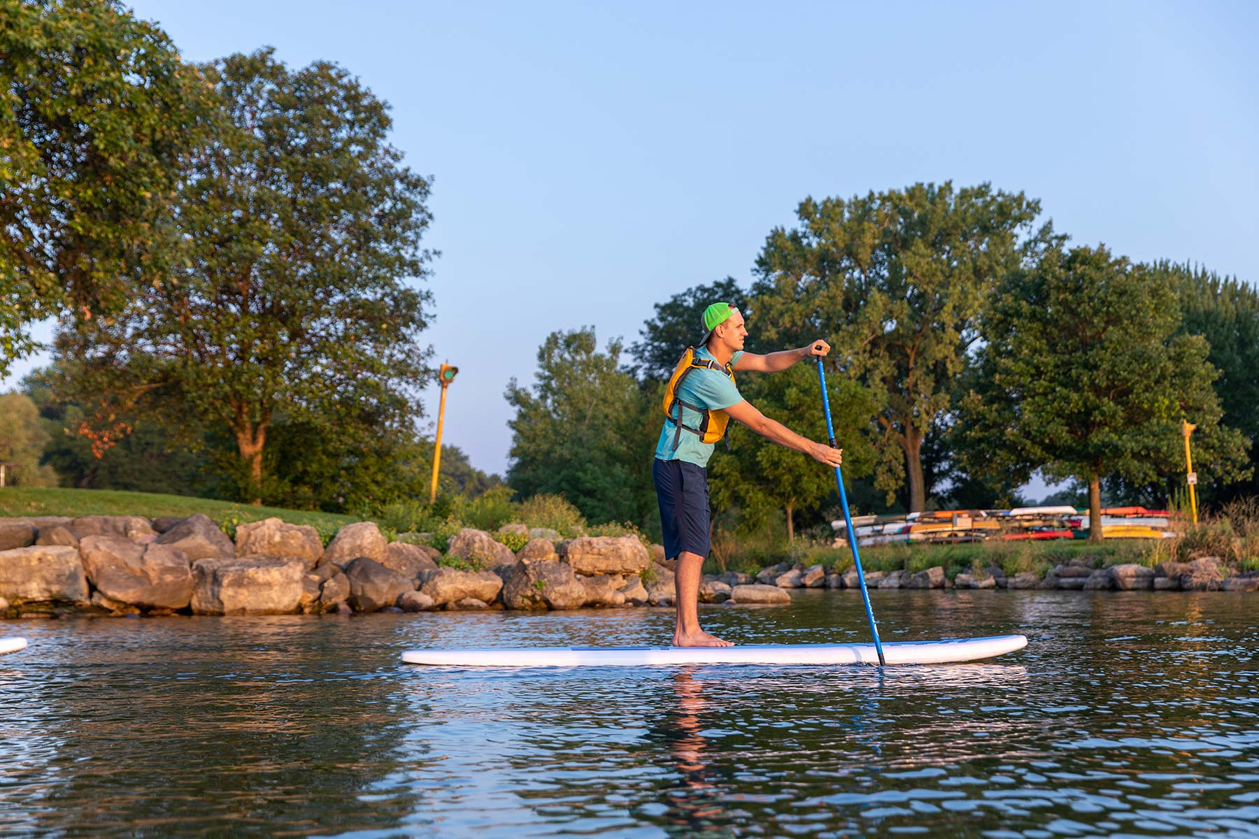 a person riding a paddle board on a body of water