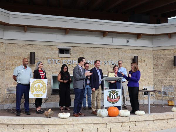 A group of people standing on a stage.