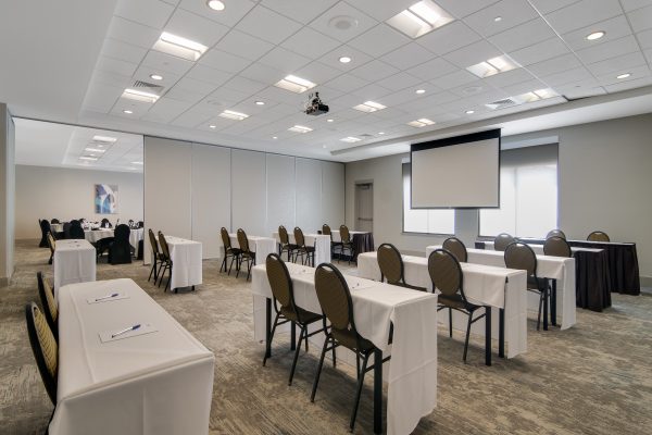 A large conference room with tables and chairs.