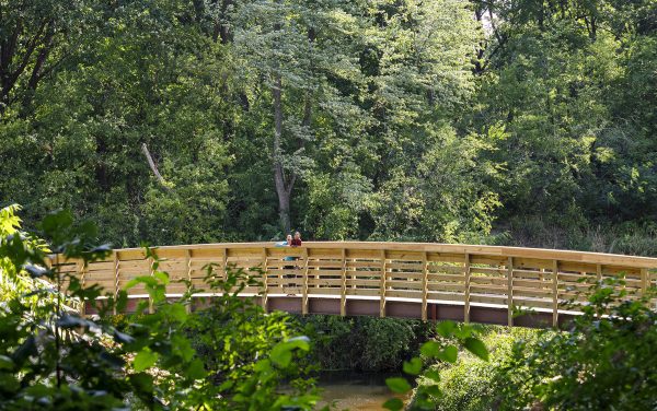 A wooden bridge over a river.