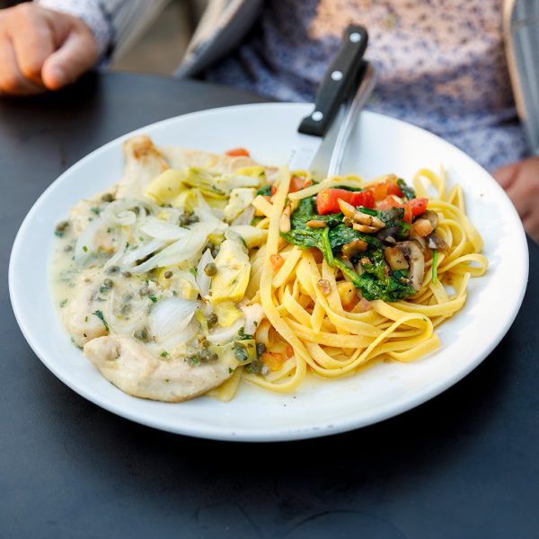A plate of spaghetti and meatballs on a table.