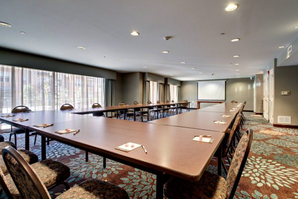 A conference room with a long table and chairs.