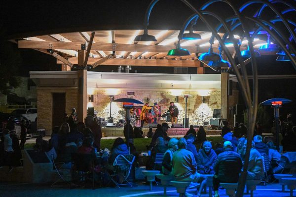 a group of people sitting in chairs in front of a building